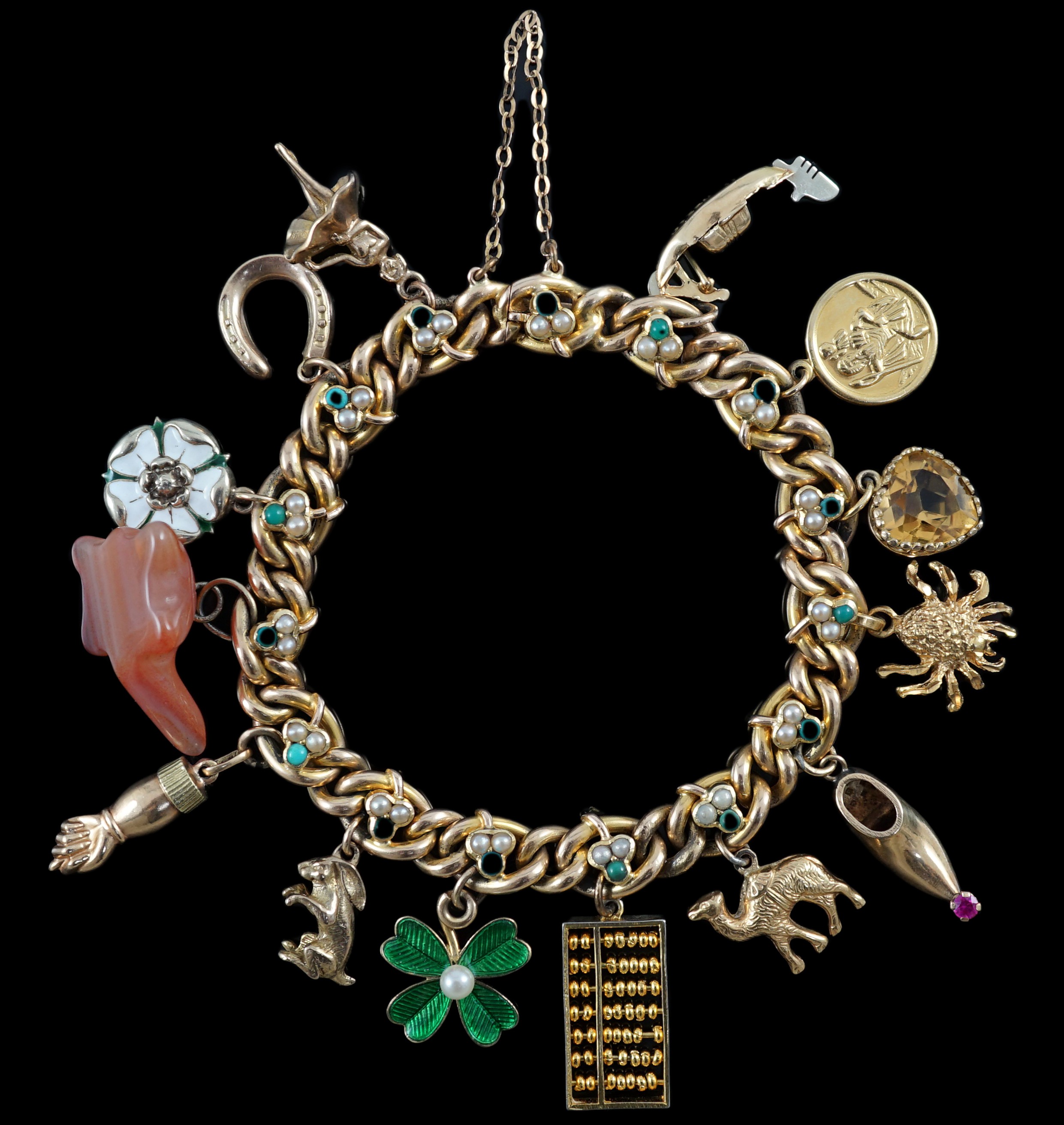 An Edwardian 15ct gold, seed pearl and turquoise set curb link charm bracelet